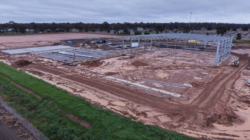 Aerial view of a Silverfox Management industrial project under construction, with the steel portal frame erected and slab works underway